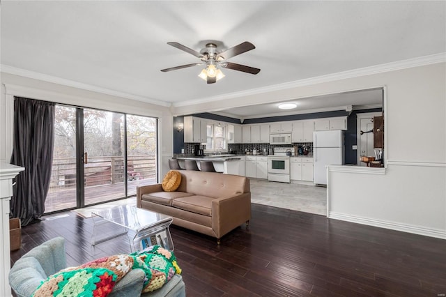 living room with sink, crown molding, ceiling fan, and dark hardwood / wood-style flooring