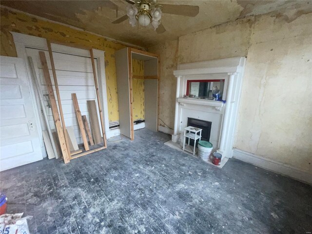 unfurnished living room featuring ceiling fan