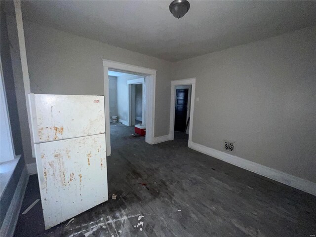 spare room featuring dark hardwood / wood-style floors