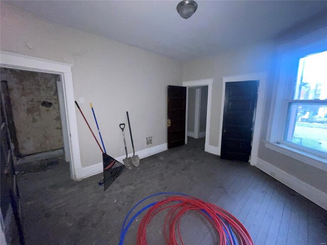 unfurnished bedroom with dark wood-type flooring