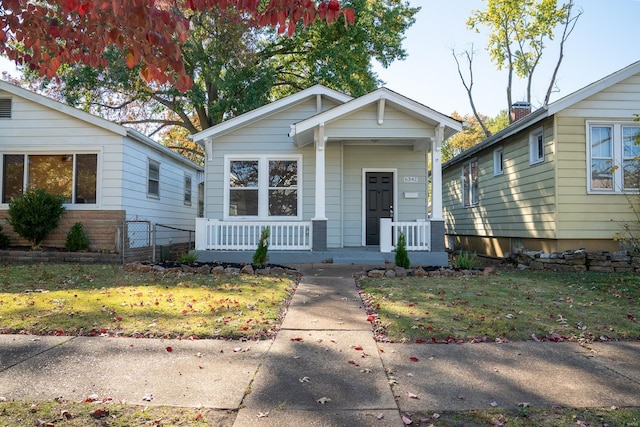 bungalow featuring a front yard and a porch