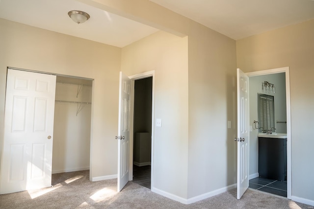 unfurnished bedroom with a closet and carpet