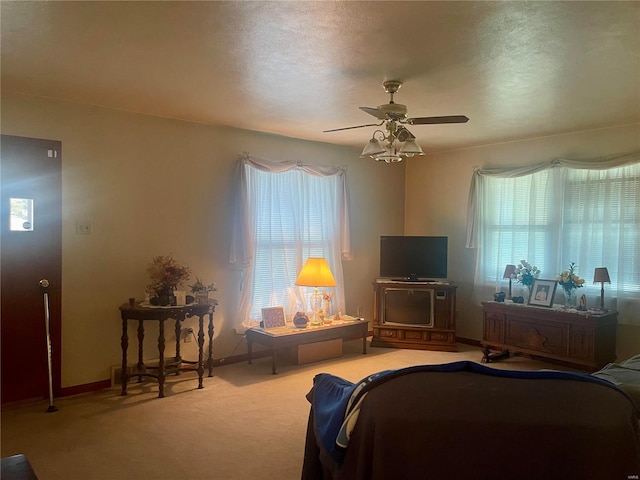 living room with ceiling fan, carpet floors, a healthy amount of sunlight, and a textured ceiling