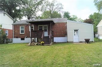 back of house with a lawn