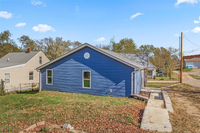 view of side of home featuring a yard