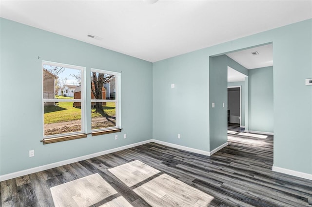 spare room featuring dark hardwood / wood-style flooring