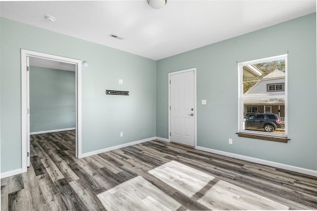 spare room featuring dark hardwood / wood-style flooring