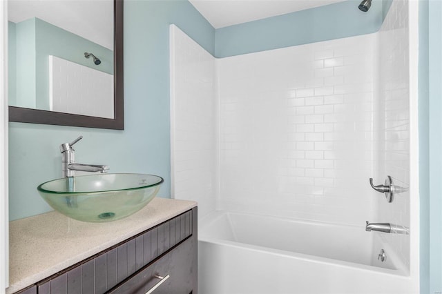 bathroom with tiled shower / bath combo and vanity