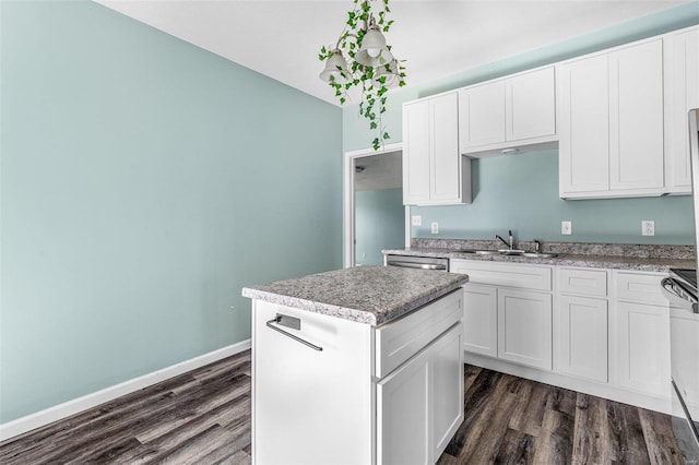 kitchen featuring sink, white cabinets, a kitchen island, dark wood-type flooring, and dishwasher