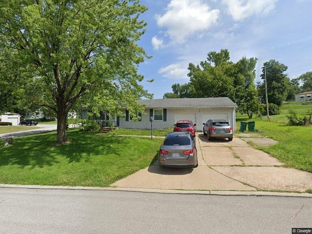 view of front of home with a front yard and a garage