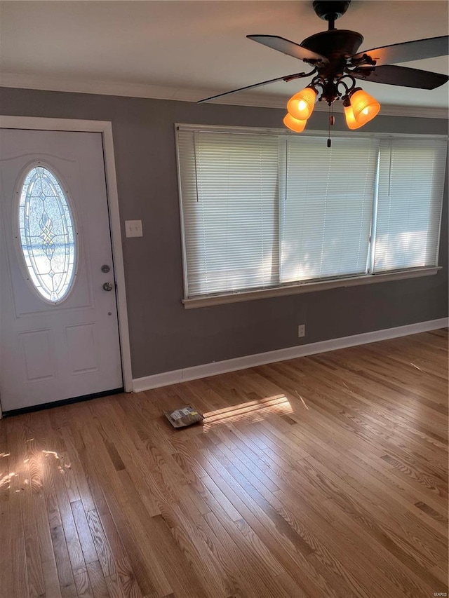 foyer featuring ornamental molding, hardwood / wood-style floors, and ceiling fan