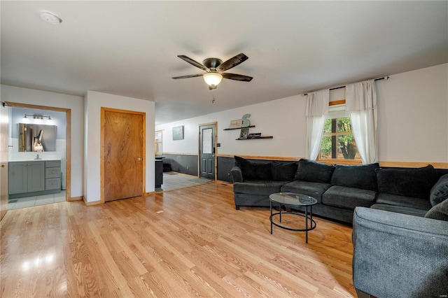 living room featuring light hardwood / wood-style flooring and ceiling fan