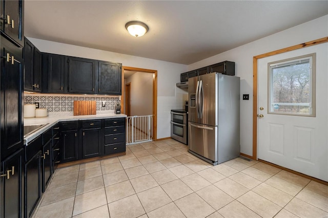 kitchen featuring stainless steel appliances, light tile patterned floors, and tasteful backsplash