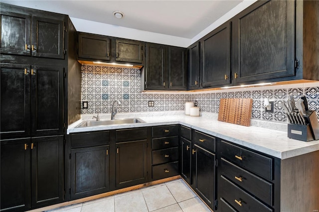 kitchen featuring decorative backsplash, sink, and light tile patterned floors