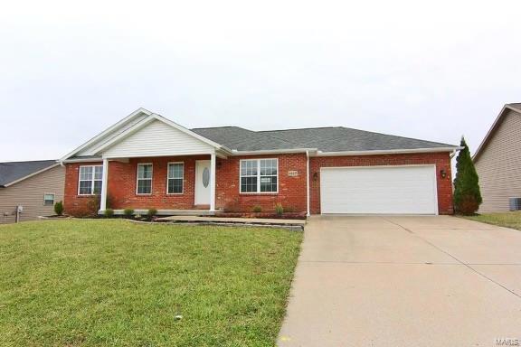 single story home with a front yard and a garage