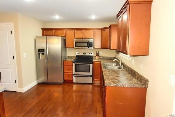 kitchen with sink, dark wood-type flooring, and stainless steel appliances