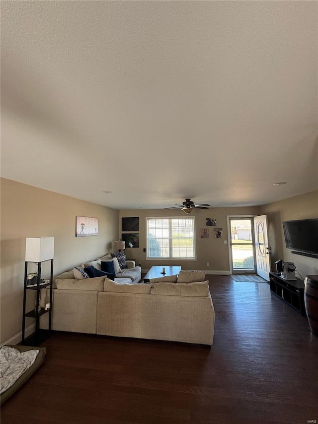 living room with ceiling fan and dark hardwood / wood-style flooring