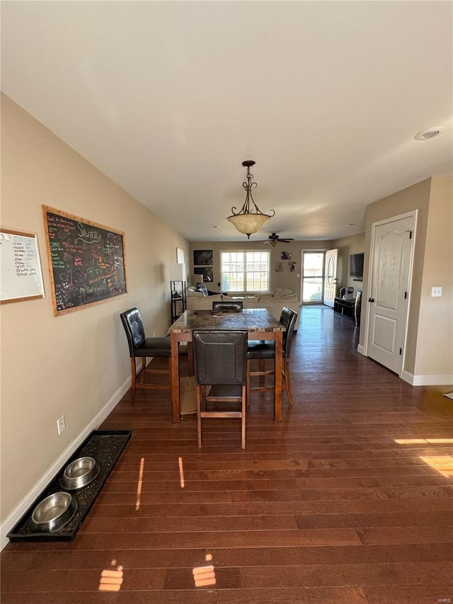 dining area with dark hardwood / wood-style floors and ceiling fan