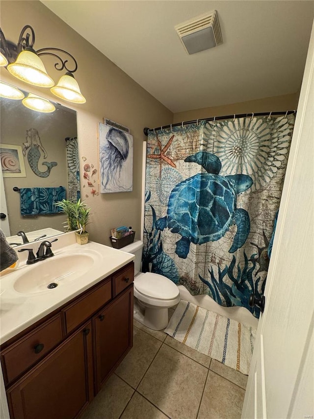 bathroom featuring vanity, walk in shower, toilet, and tile patterned flooring