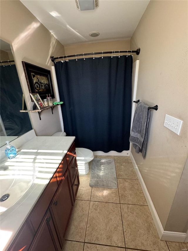 bathroom featuring vanity, toilet, and tile patterned floors