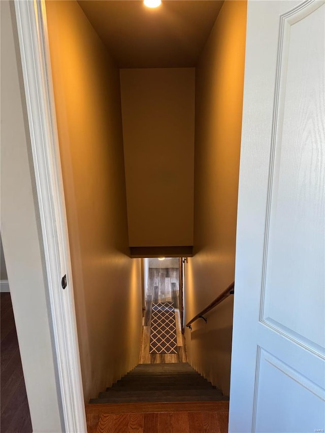 stairs featuring hardwood / wood-style floors