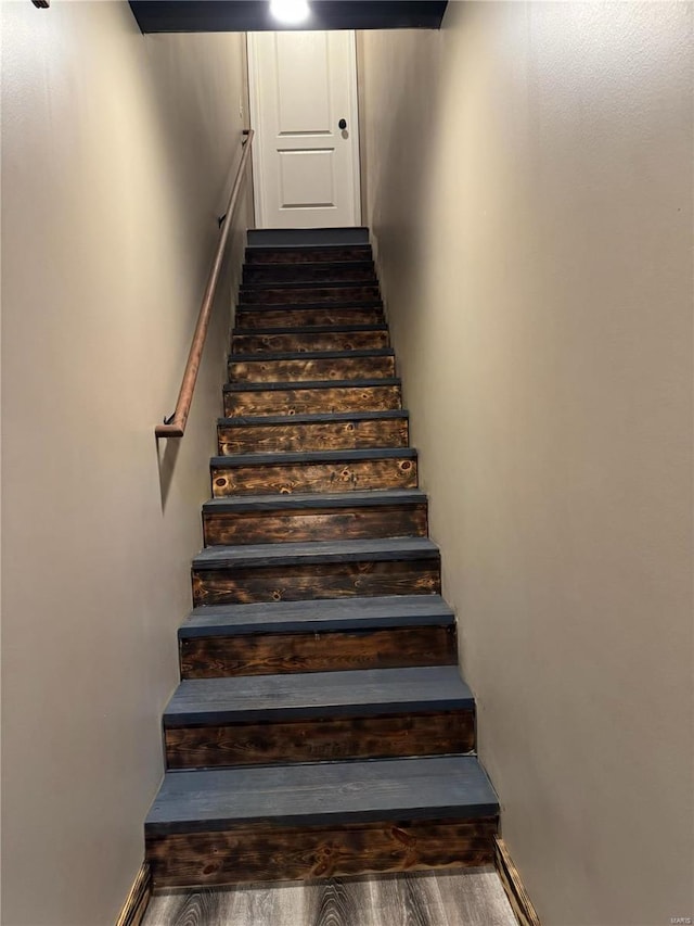 stairs featuring hardwood / wood-style flooring