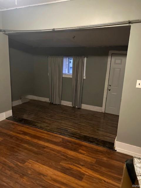 basement with dark hardwood / wood-style flooring