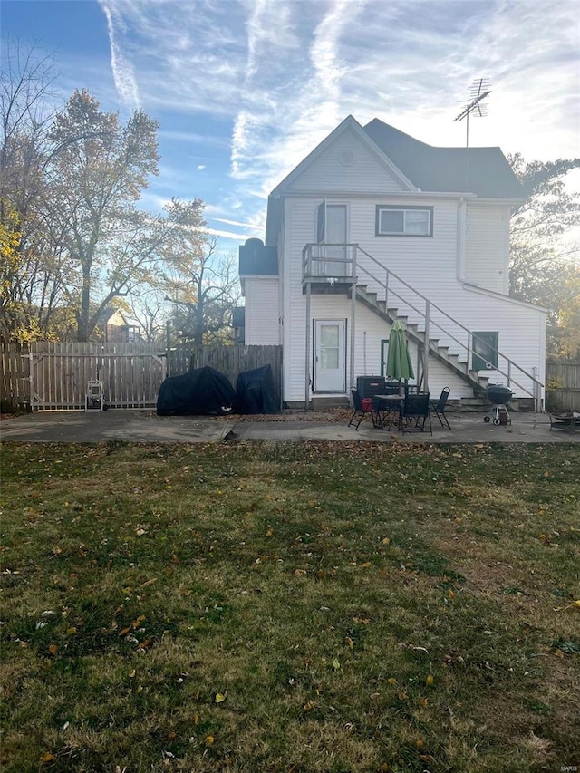 back of house featuring a yard and a patio