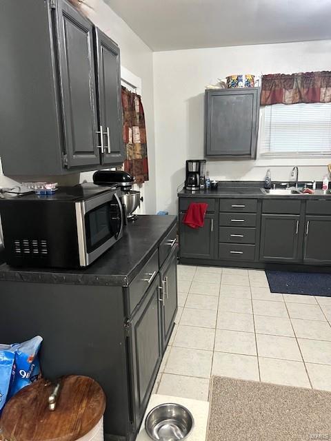 kitchen with sink, gray cabinetry, and light tile patterned floors