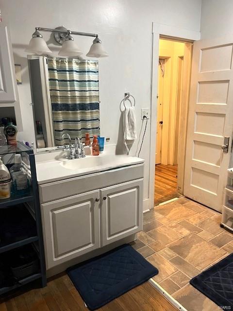 bathroom with vanity and hardwood / wood-style floors