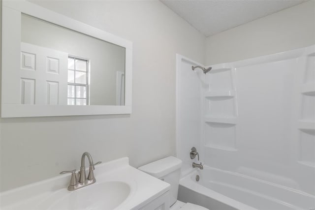 full bathroom featuring vanity, toilet, a textured ceiling, and  shower combination