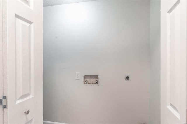 clothes washing area with a textured ceiling, washer hookup, and hookup for an electric dryer