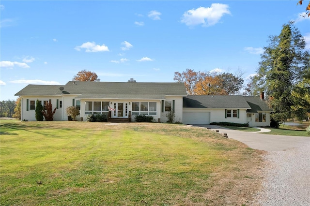 ranch-style home featuring a front yard and a garage