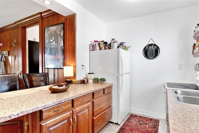 kitchen featuring white fridge and sink