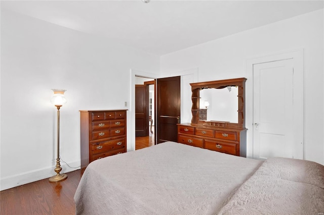 bedroom with dark hardwood / wood-style flooring