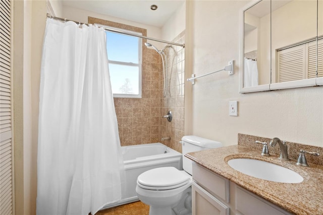 full bathroom with vanity, shower / tub combo, and toilet