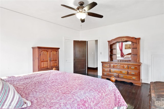 bedroom with dark hardwood / wood-style flooring and ceiling fan