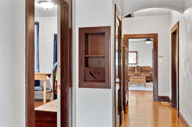 hallway with light hardwood / wood-style flooring