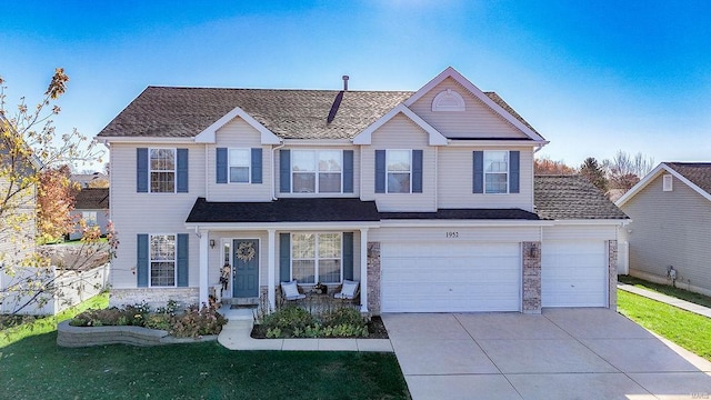 view of front of house featuring a garage and a front lawn