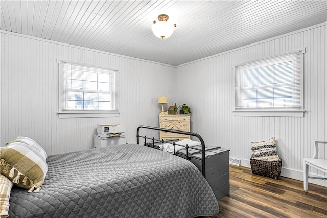 bedroom featuring dark hardwood / wood-style flooring, multiple windows, and wood ceiling