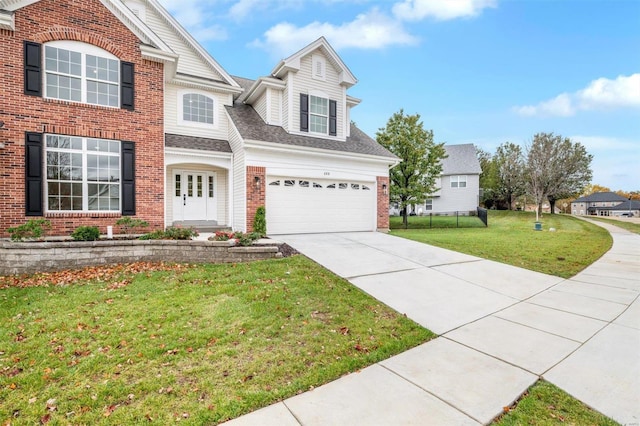 view of front of house featuring a front lawn and a garage