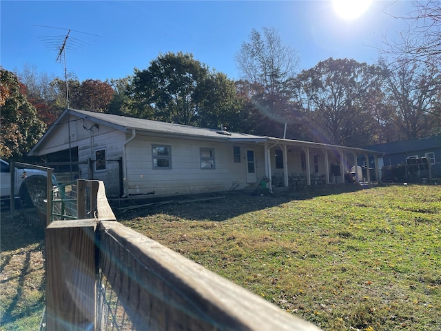 rear view of house with a lawn