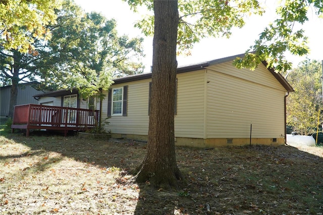 view of side of property featuring a deck