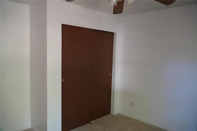 carpeted empty room with ceiling fan