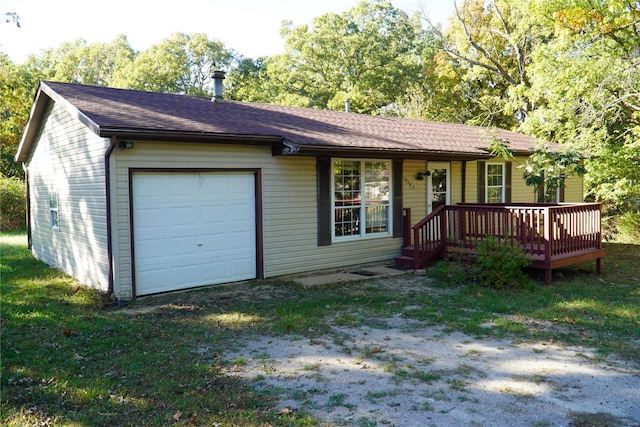 ranch-style home with a front yard, a garage, and a deck