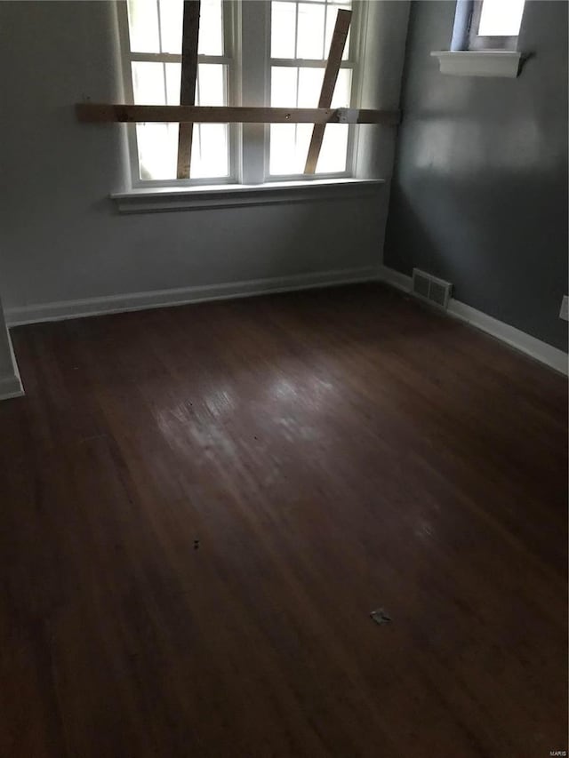 empty room featuring dark hardwood / wood-style flooring