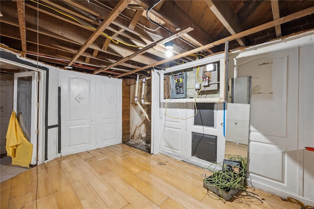 basement with light hardwood / wood-style flooring