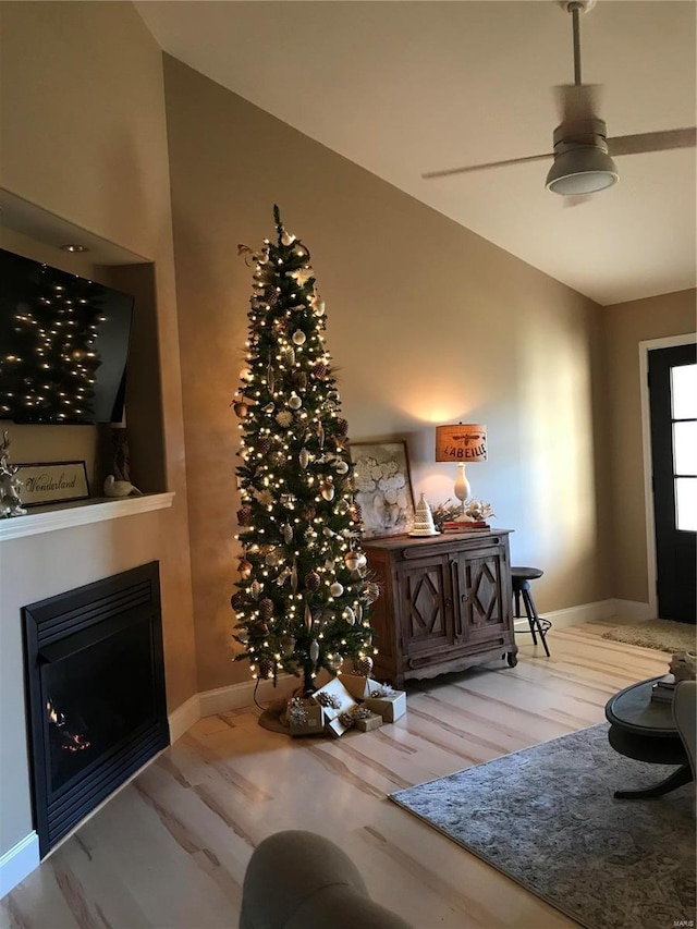 foyer entrance with ceiling fan, lofted ceiling, and hardwood / wood-style floors