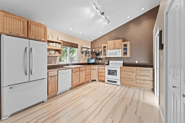 kitchen featuring light brown cabinetry, lofted ceiling, sink, track lighting, and white appliances