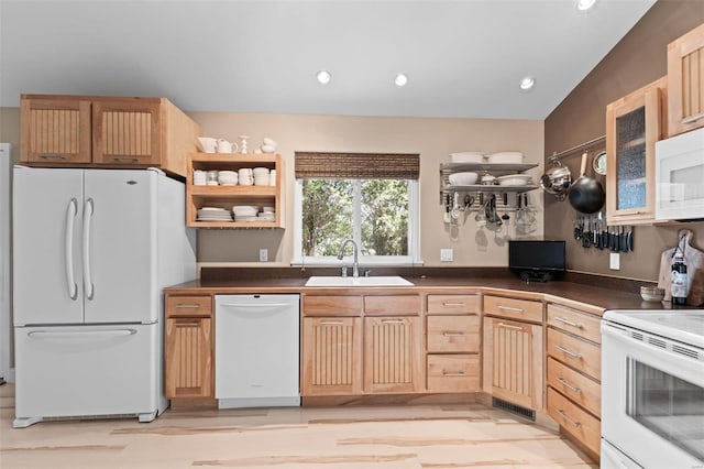 kitchen with light brown cabinetry, sink, white appliances, and lofted ceiling